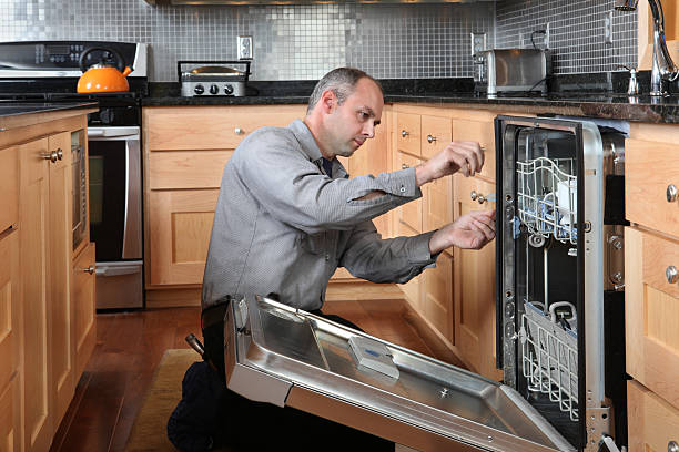 Technician fixing LG dishwasher in Los Angeles kitchen