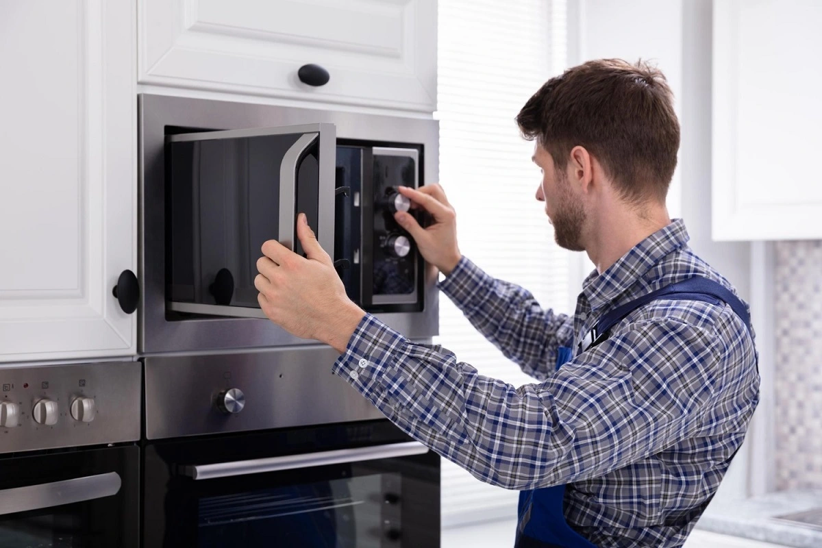 man repairing Microwave
